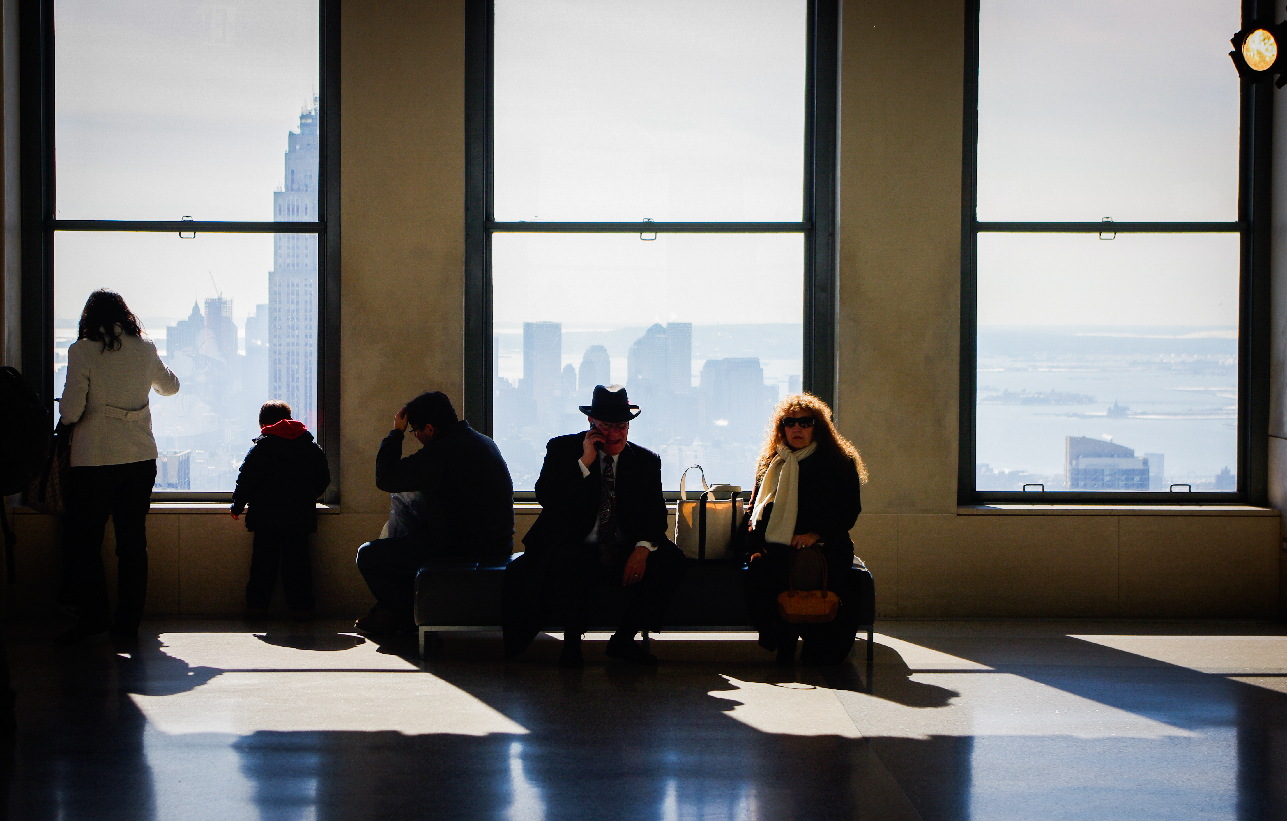 People silhouetted against NYC windows