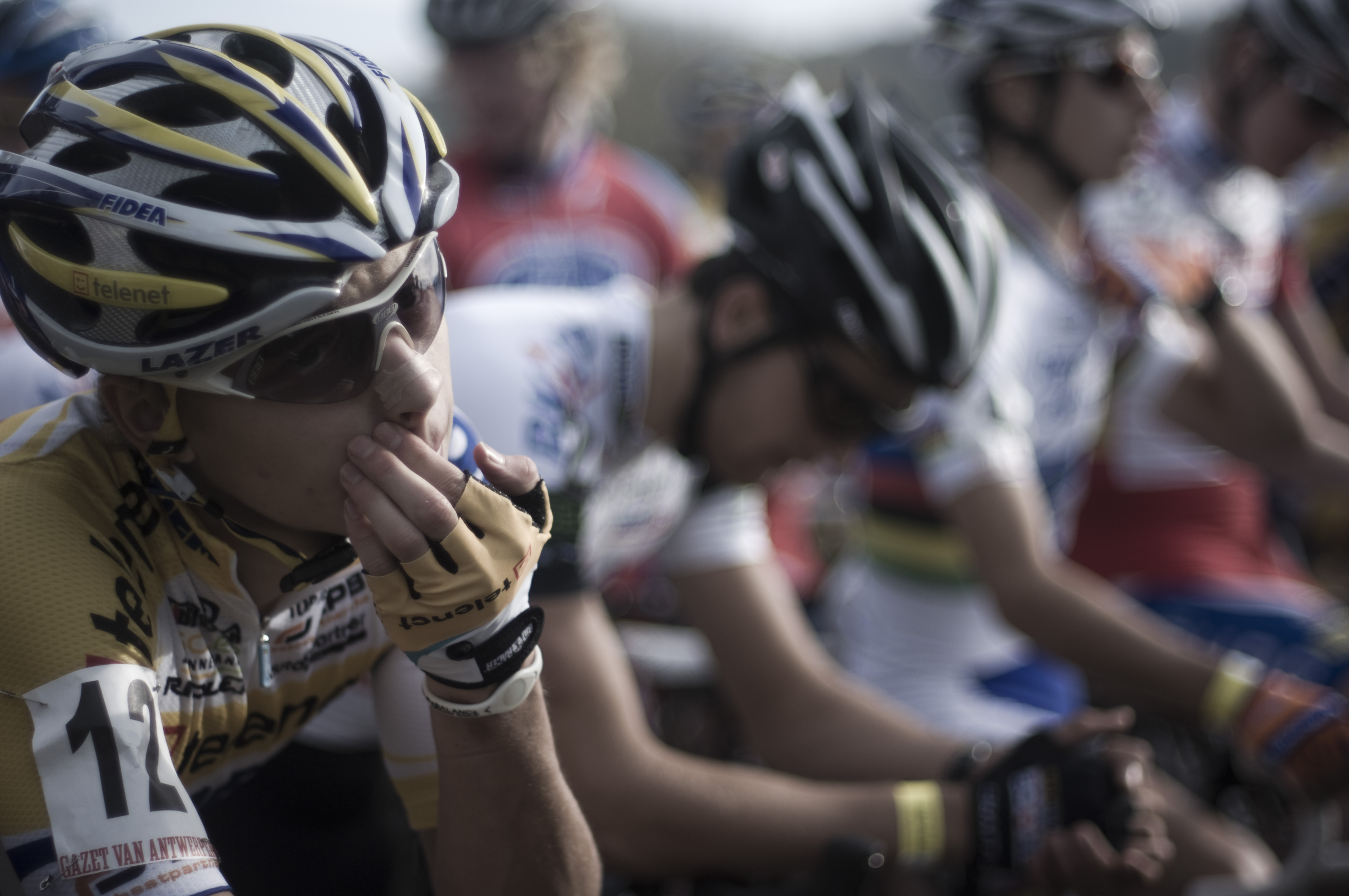 Cyclist waiting / hand at mouth