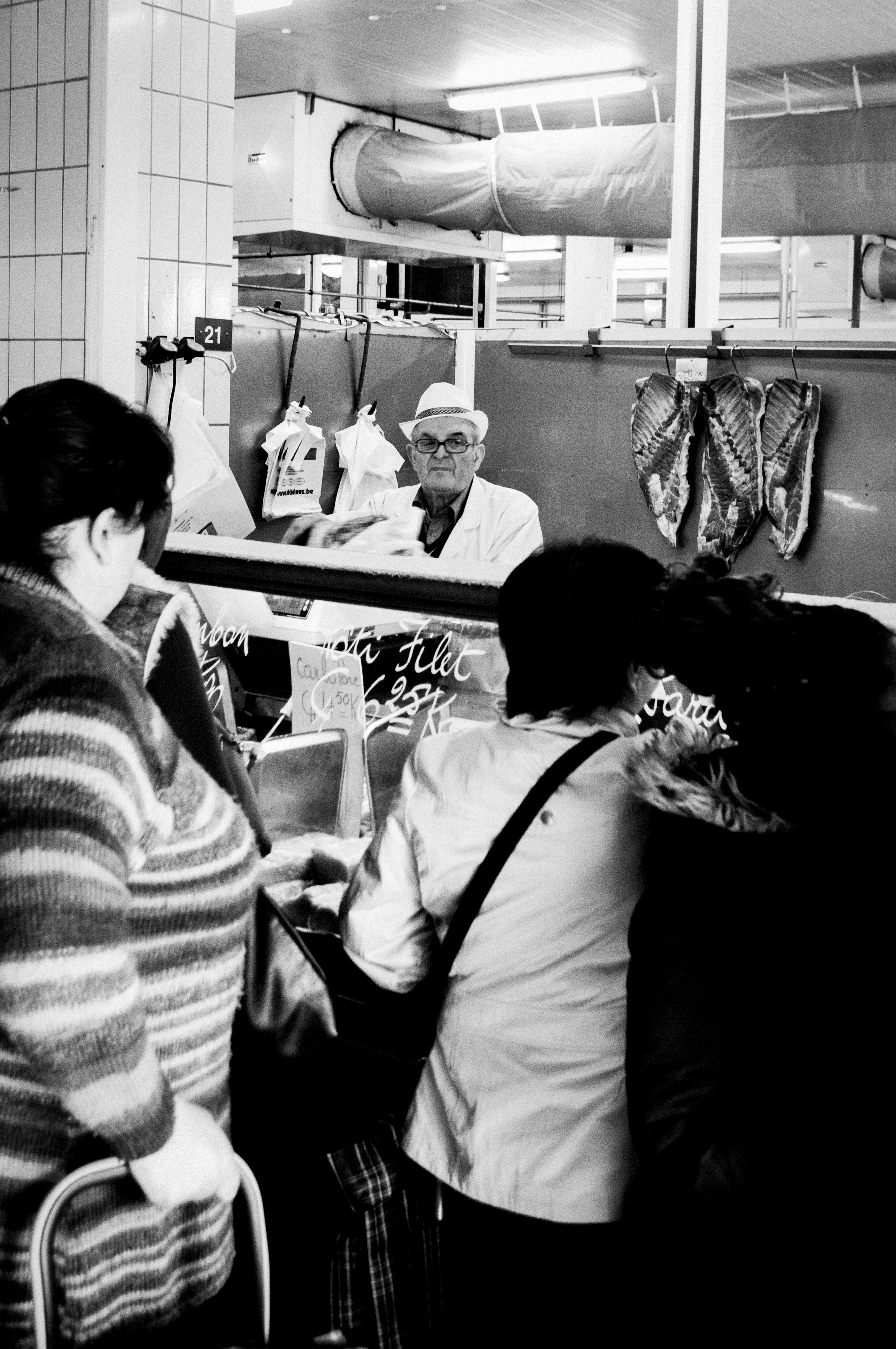 Butcher behind market counter