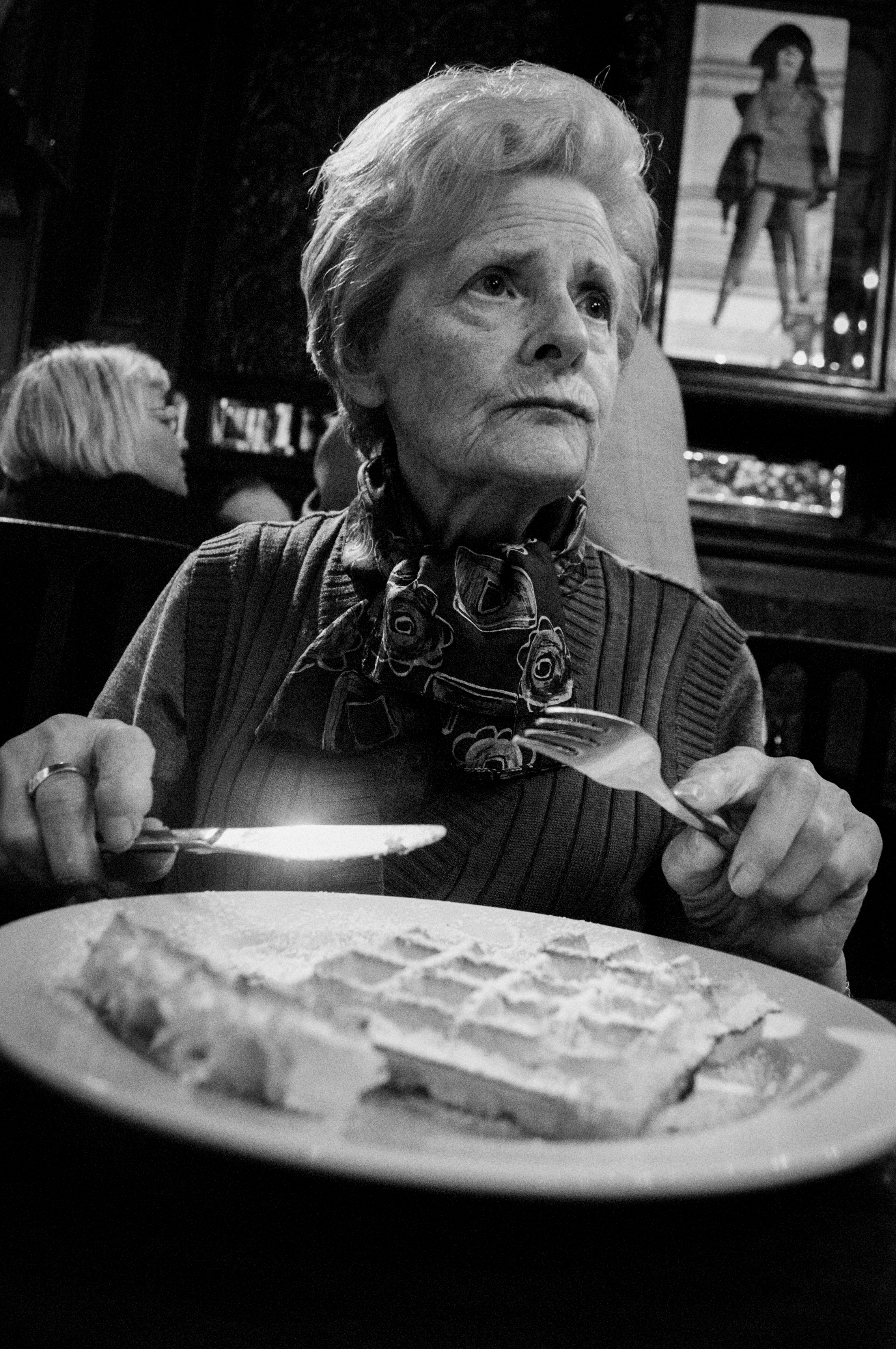 Older woman eating at table