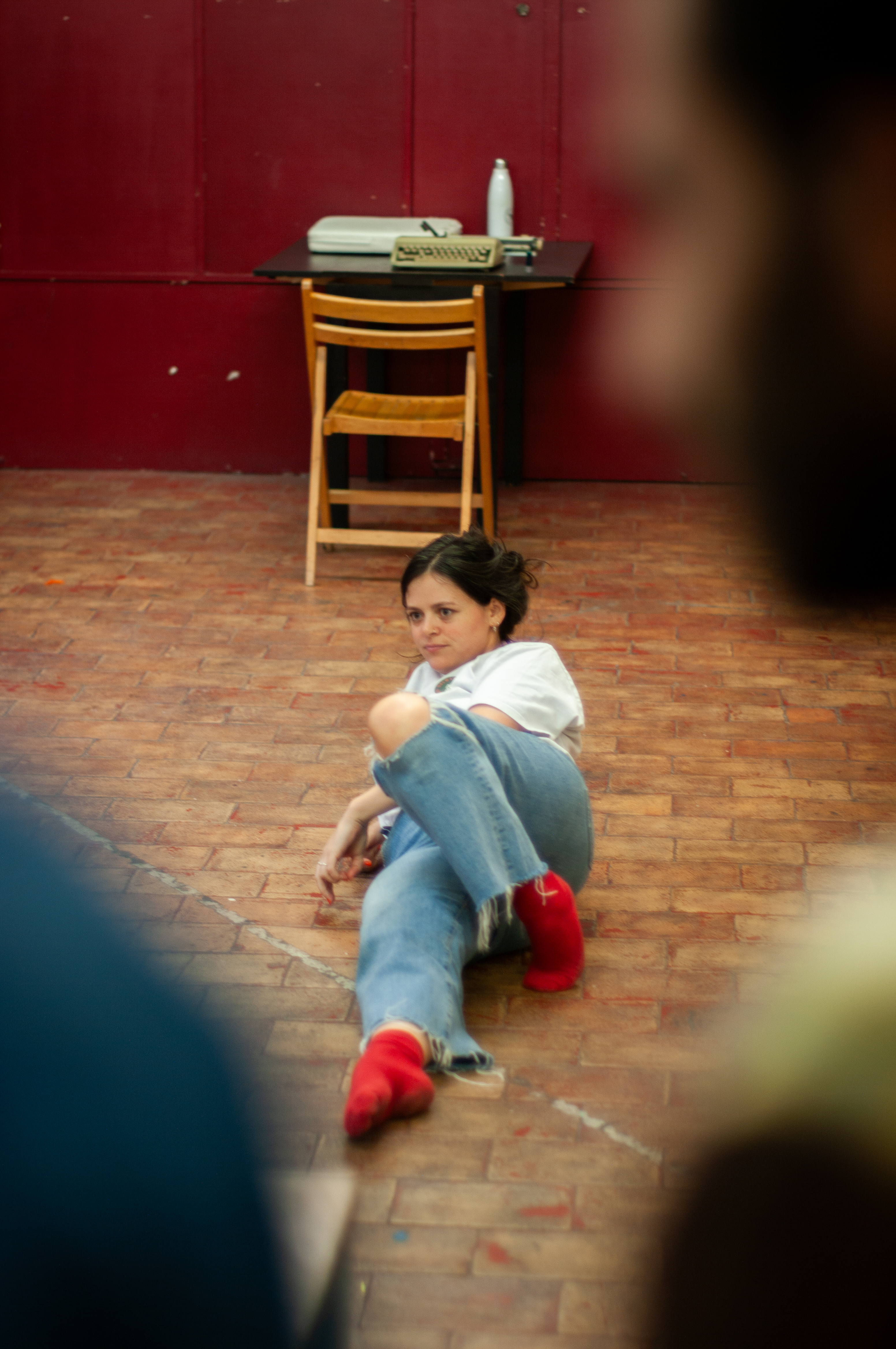Performer on the floor in red socks