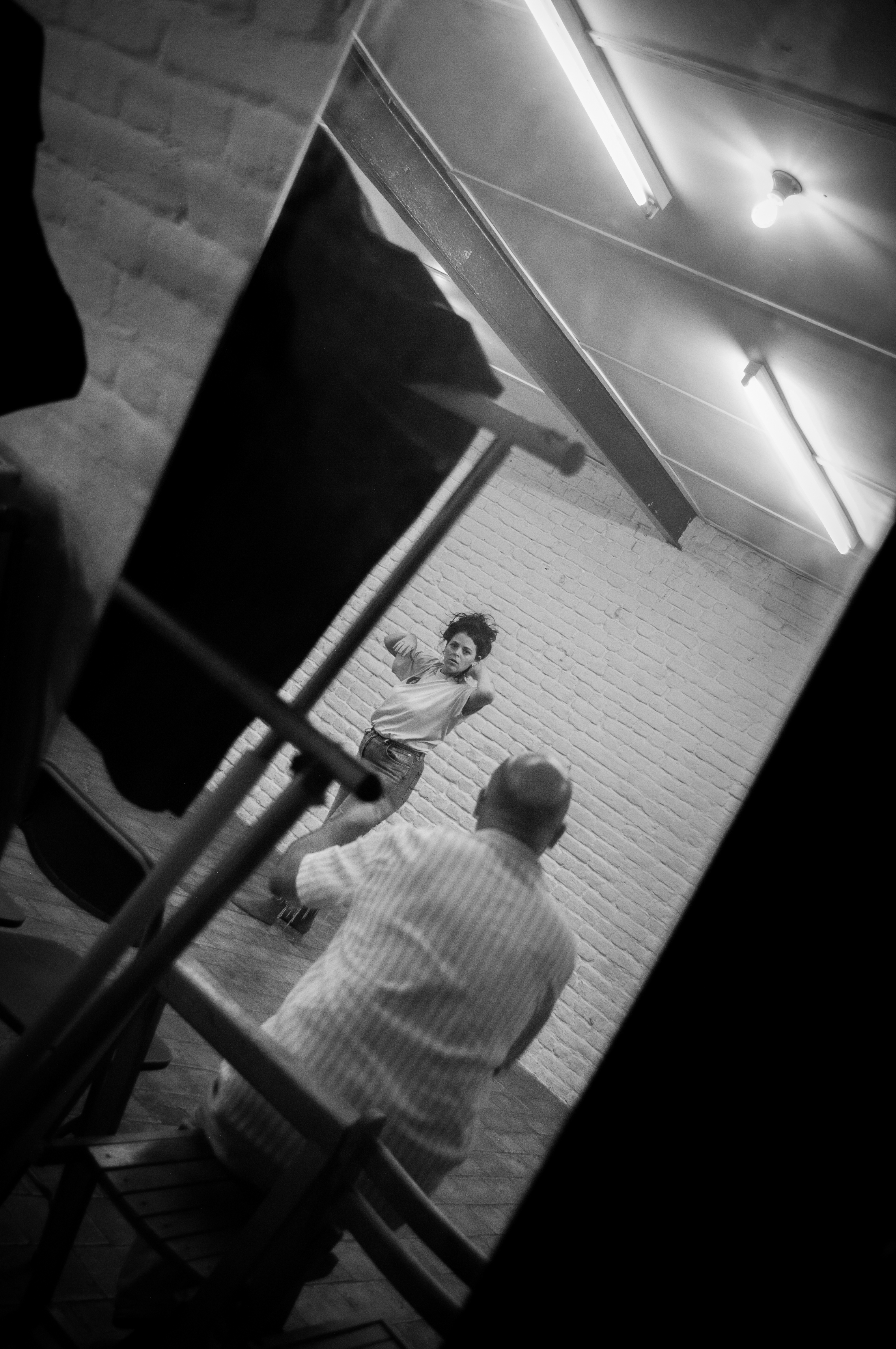 Rehearsal seen through chairs in black and white