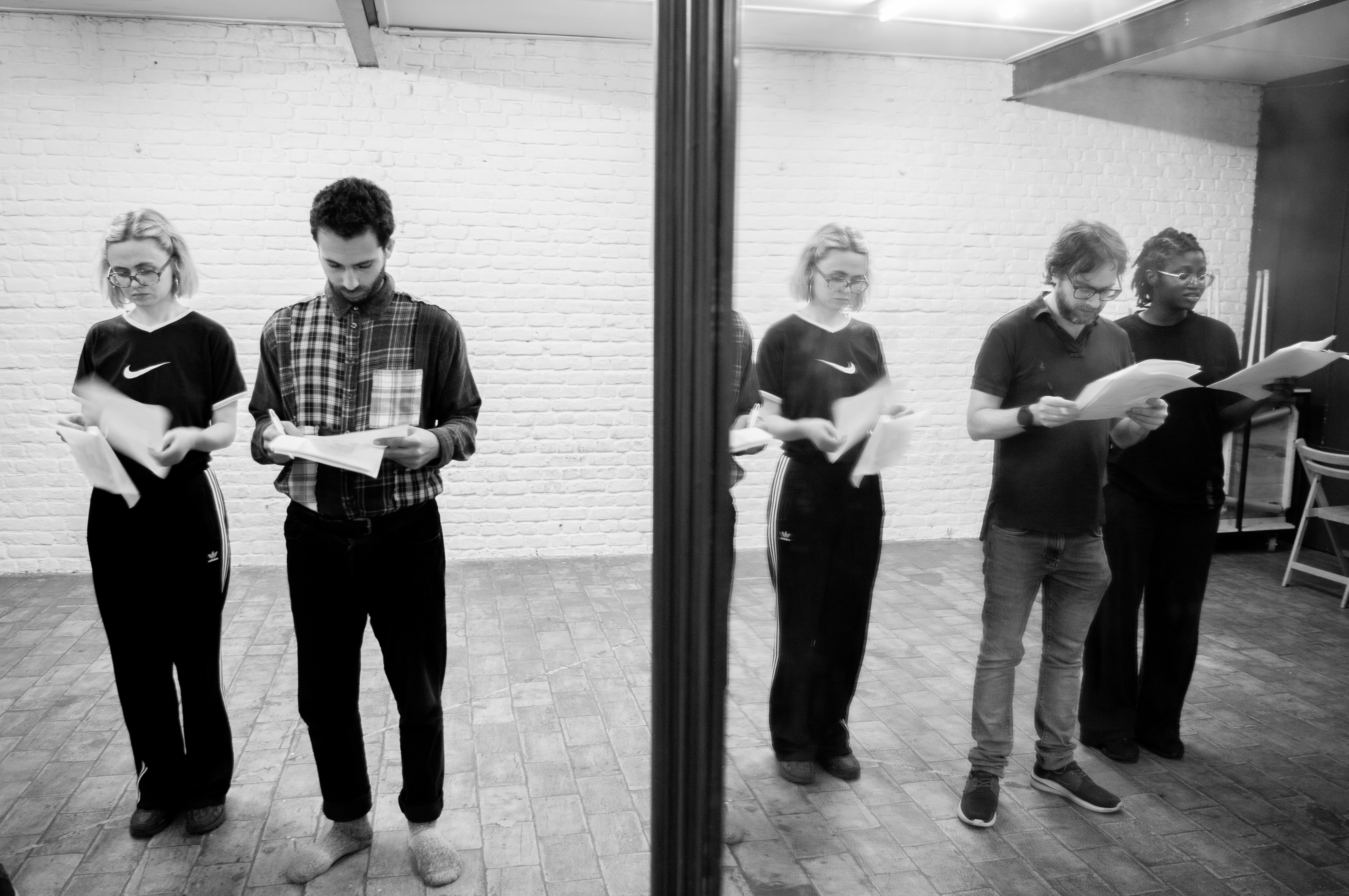 Ensemble reading scripts beside a mirror